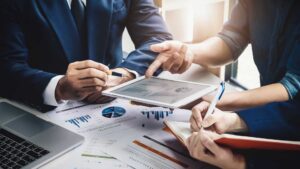 A 12-month implementation roadmap showing the phased transition from a player-coach model to a dedicated sales manager to improve win rates.