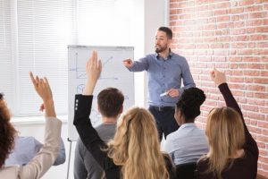 A sales manager providing b2b sales training to an employee to improve sales coaching effectiveness and team productivity