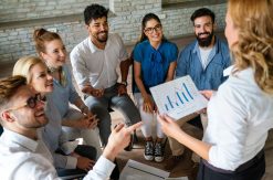 Sales team in a classroom setting learning about sales skill optimization and sales coaching benefits