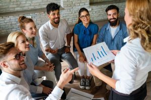 Sales team in a classroom setting learning about sales skill optimization and sales coaching benefits